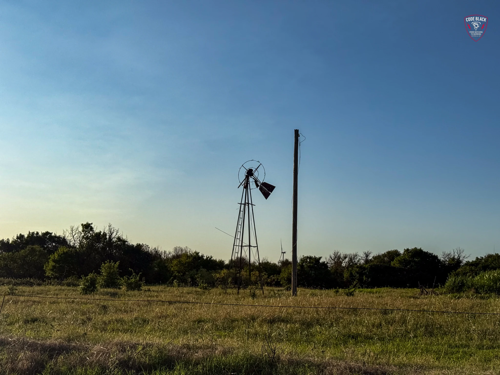 A rural windmill beneath an open sky