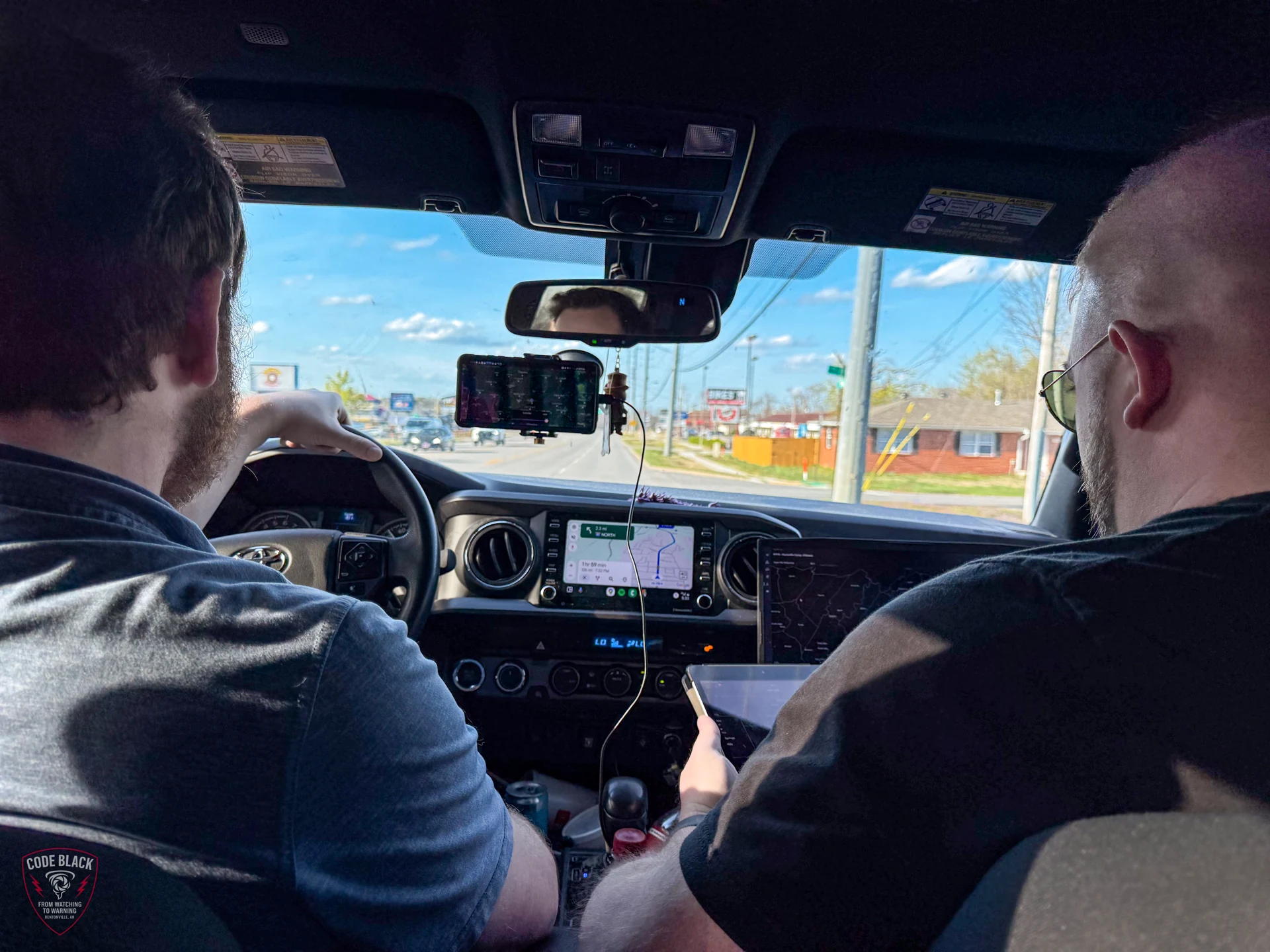 Nick driving with Spencer beside him during a chase